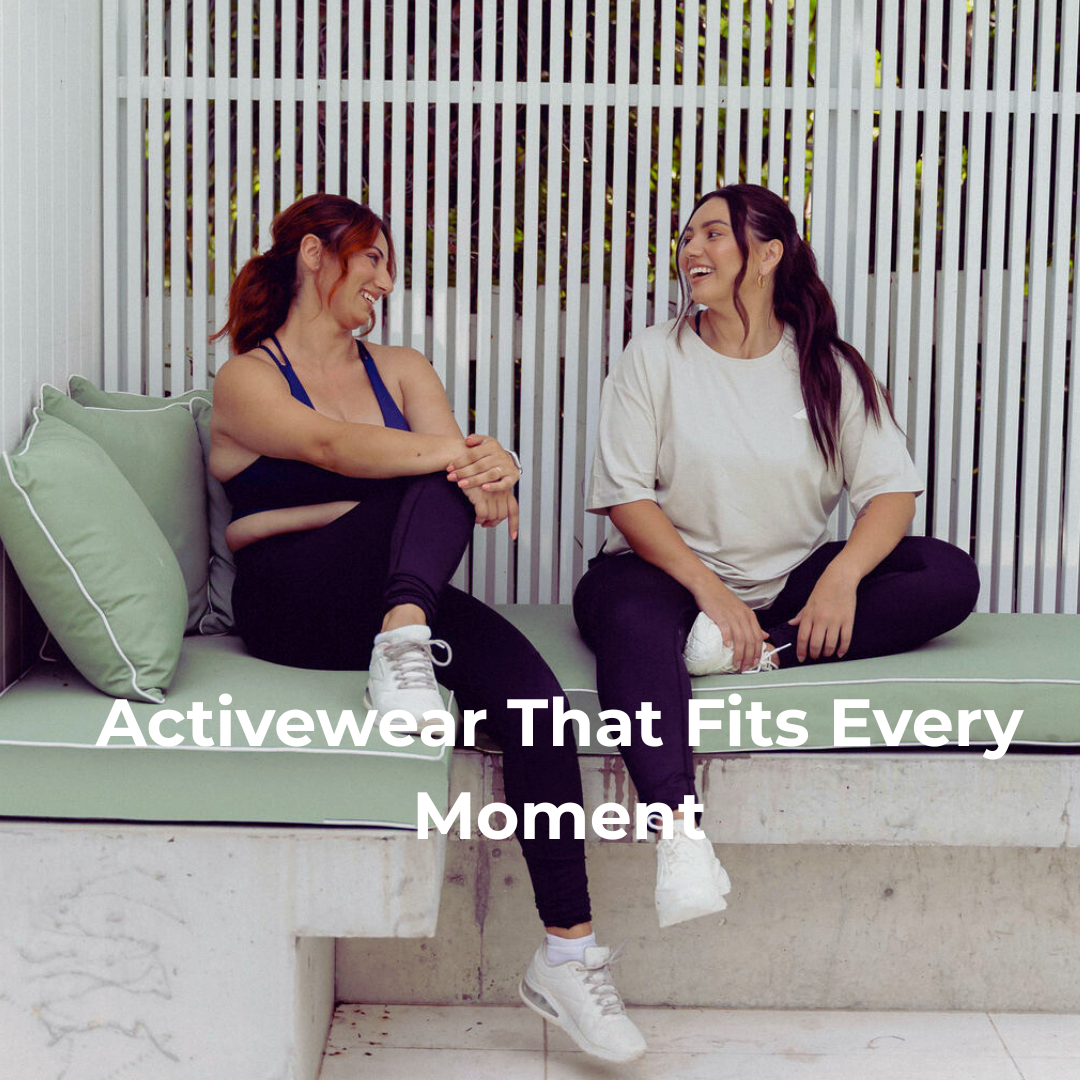 Two women dressed in Active Elite Activewear, sitting on a bench seat appearing happy while chatting 