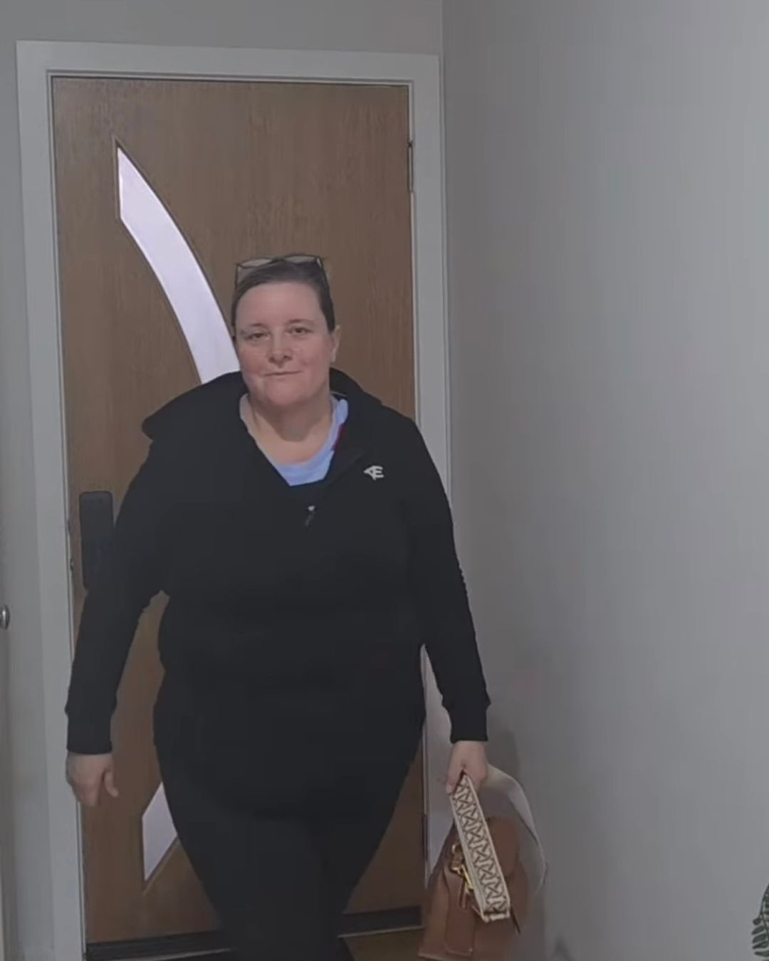 woman wearing black hood jacket and leggings with pockets