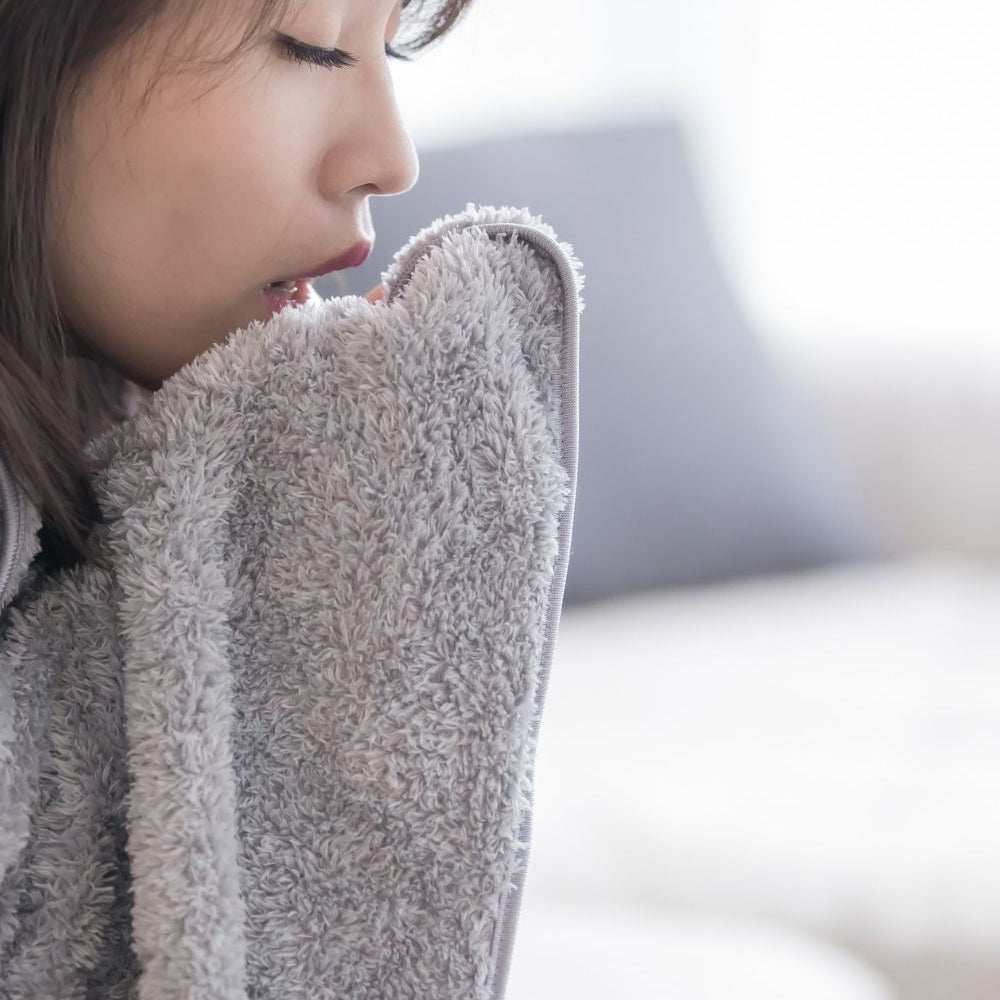 woman wrapped in a blanket with text over lay