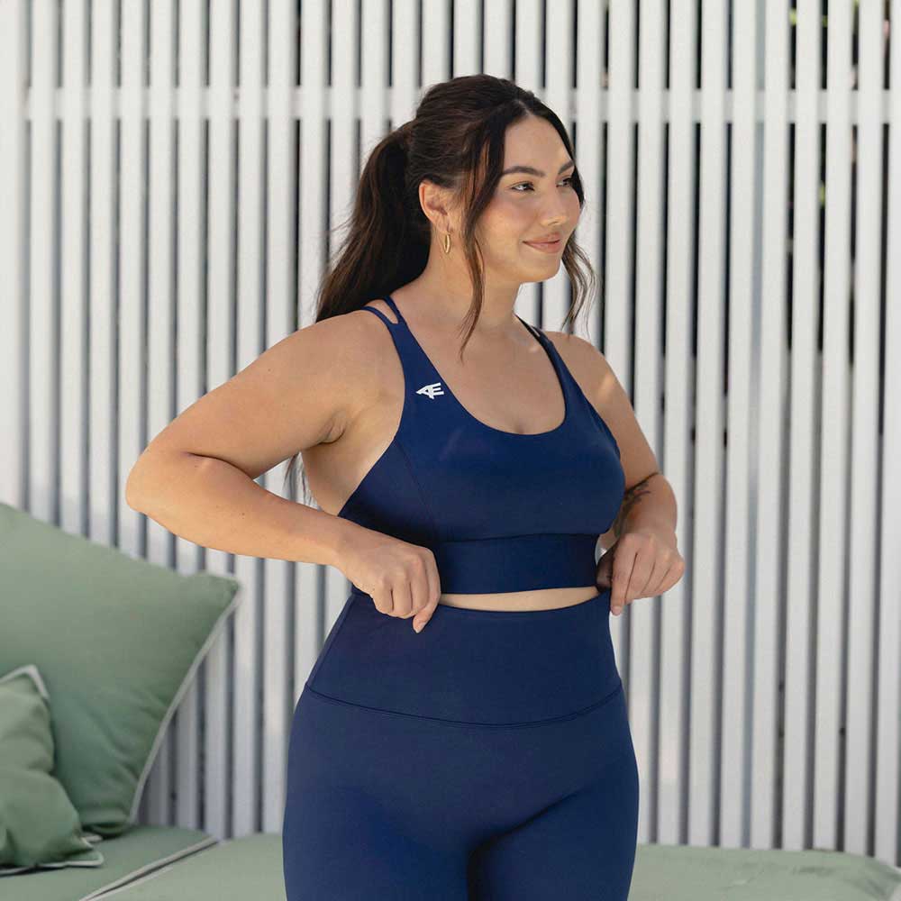 A side view of a woman, showing off the seamless fit and support of the activewear.