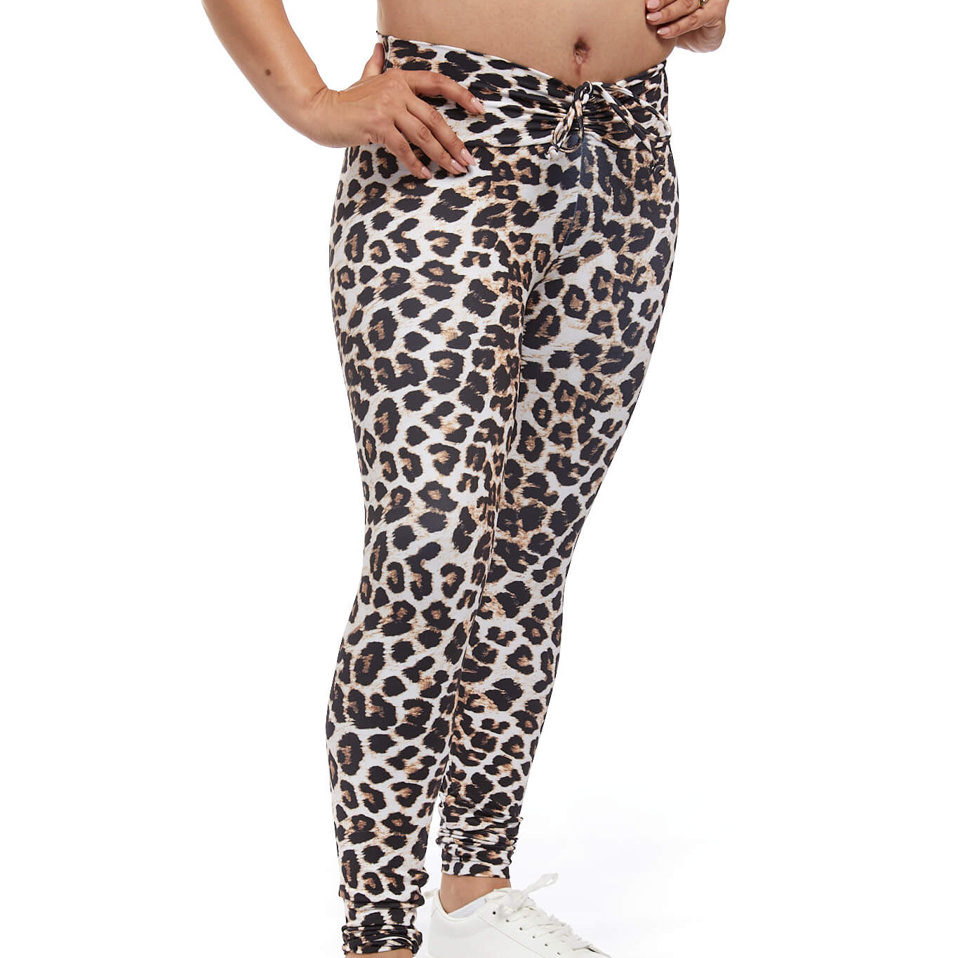 close up of woman wearing leopard print scrunch activewear leggings. Hands are on hips. White background